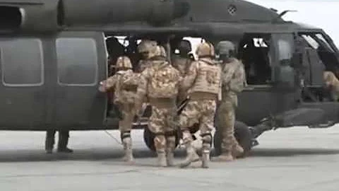 Romanian troops work with US pilots to help secure...