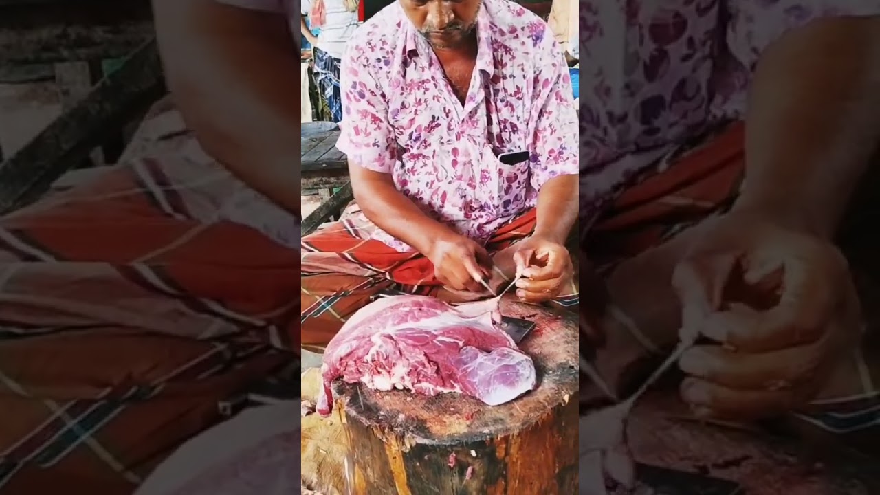 A skillful butcher cuts beef in a beautiful setting 