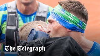 Kevin Sinfield carries Rob Burrow over Leeds marathon finish