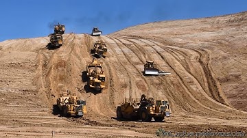 CAT 657 Scrapers eating away hillside