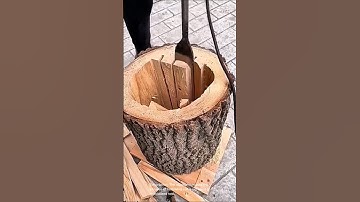 The process of hollowing out a log using a specialized tool