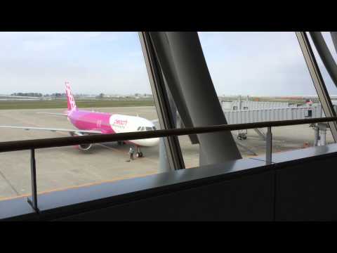 Peach airlines airplane pulling into Sendai airport.