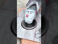 Tiler cuts perfect circular hole in ceramic tile using grinder