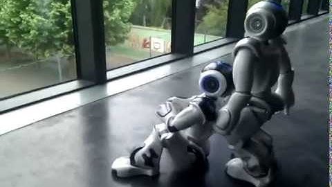 One NAO helps another to stand up