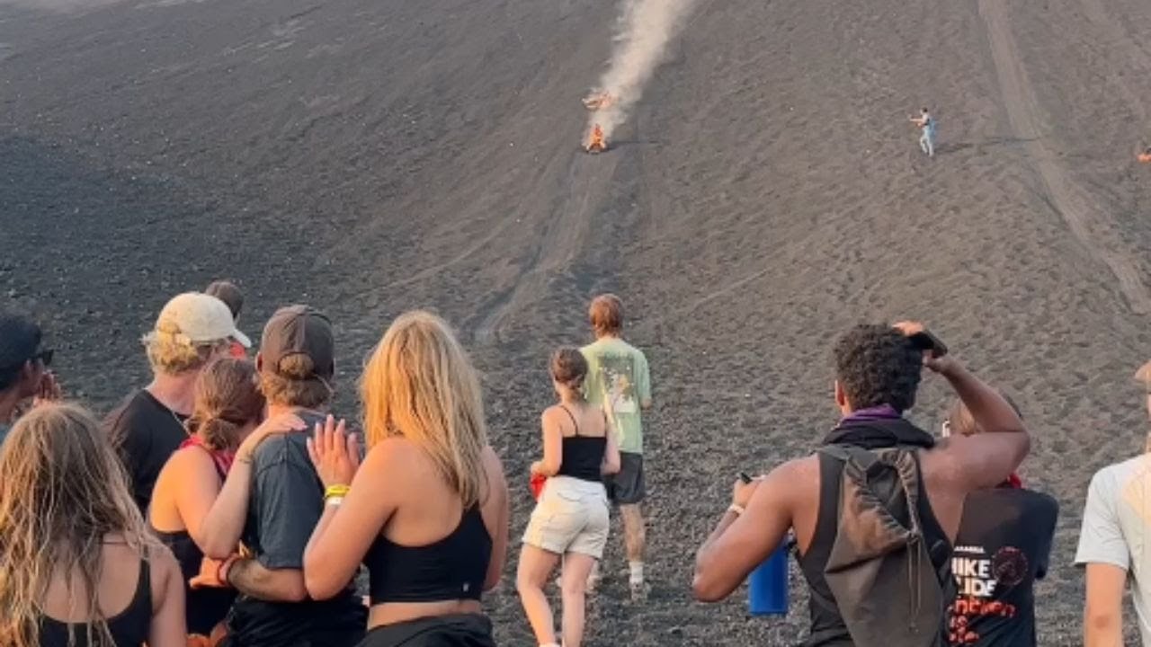 Volcano-boarding adventure turns dangerous as surfers dodge a crashing object at 71 km/hr.
