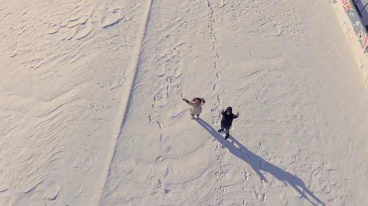 happy girl and guy waves hands to drone