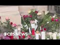 Tina Turner's neighbors place flowers and candles outside her Switzerland home