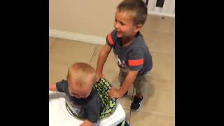 Boy pushes baby brother in walker and runs into table