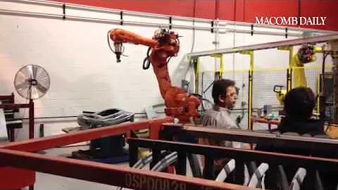 R&E workers show Romeo students how car door assembly is done with help of robotics. @macombdaily