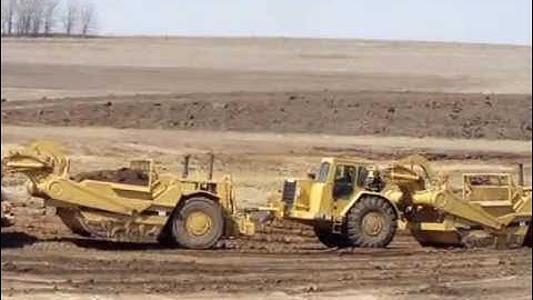 Twin engine 637E Scrapers building a pond