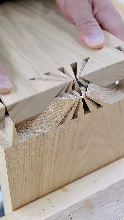 Advanced woodworking technique creating a complex geometric corner joint