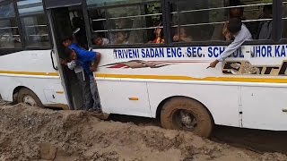 School bus stuck in muddy road in Kathmandu