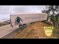 Tractor trailer left hanging off the freeway after heavy rain