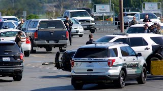 Knife wielding man swarmed by police, taken into custody in Kennewick store parking lot