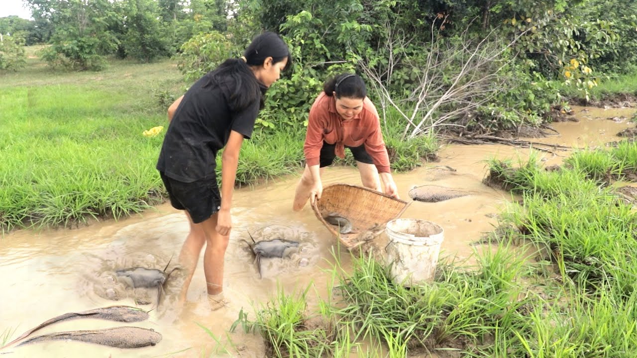 Two girls catch big fish using traditional tools