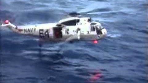 Helicopter drops Diver at Apollo 11 Command Module after Splashdown