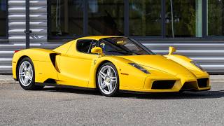 2004 Ferrari Enzo - Giallo Modena - Walkaround (4K)
Key Points: Classiche Certification Example, 3-Piece Ferrari Luggage Set, Giallo Modena Exterior Paint, Suspension Lift
Named after the companys founder, Enzo Ferrari, the mid-engined Ferrari Enzo was developed in 2002 using Formula One technology, such as a carbon fibre body, the F1-style automated manual transmission, and carbon fibre-reinforced silicon carbide (C/SiC) ceramic composite disc brakes. It also has active aerodynamics, generating substantial amounts of downforce through its front underbody flaps, adjustable rear spoiler and rear diffuser. The Enzo has four-wheel independent suspension with pushrod-actuated shock absorbers which can be adjusted from the cabin, supported by anti-roll bars at both front and rear. As standard, it rides on 19-inch wheels framing substantial Brembo disc brakes.
The Enzos rear mid-mounted ‘F140 B’ naturally aspirated 6.0-litre V12 features variable valve timing and Bosch Motronic fuel injection, and boasts a 8,200rpm redline. It produces 651hp and 485lb ft of torque, which is sent to the rear wheels via the ‘F1’ Graziano automated manual gearbox with paddle shift and steering wheel-mounted LED shift indicator lights. The gearbox has a shift time of just 150 milliseconds, resulting in a 0-60mph sprint time of 3.1 seconds, and a top speed of 218mph.
Designed by Pininfarina, a limited production run of 399 units was announced at the 2002 Paris Motor Show. The company sent invitations to existing customers, specifically, those who had previously bought the F40 or F50. In 2004, the 400th production car was built and donated to the Vatican for charity, which was later sold at auction. 2004 Ferrari Enzo - Giallo Modena - Walkaround (4K)
