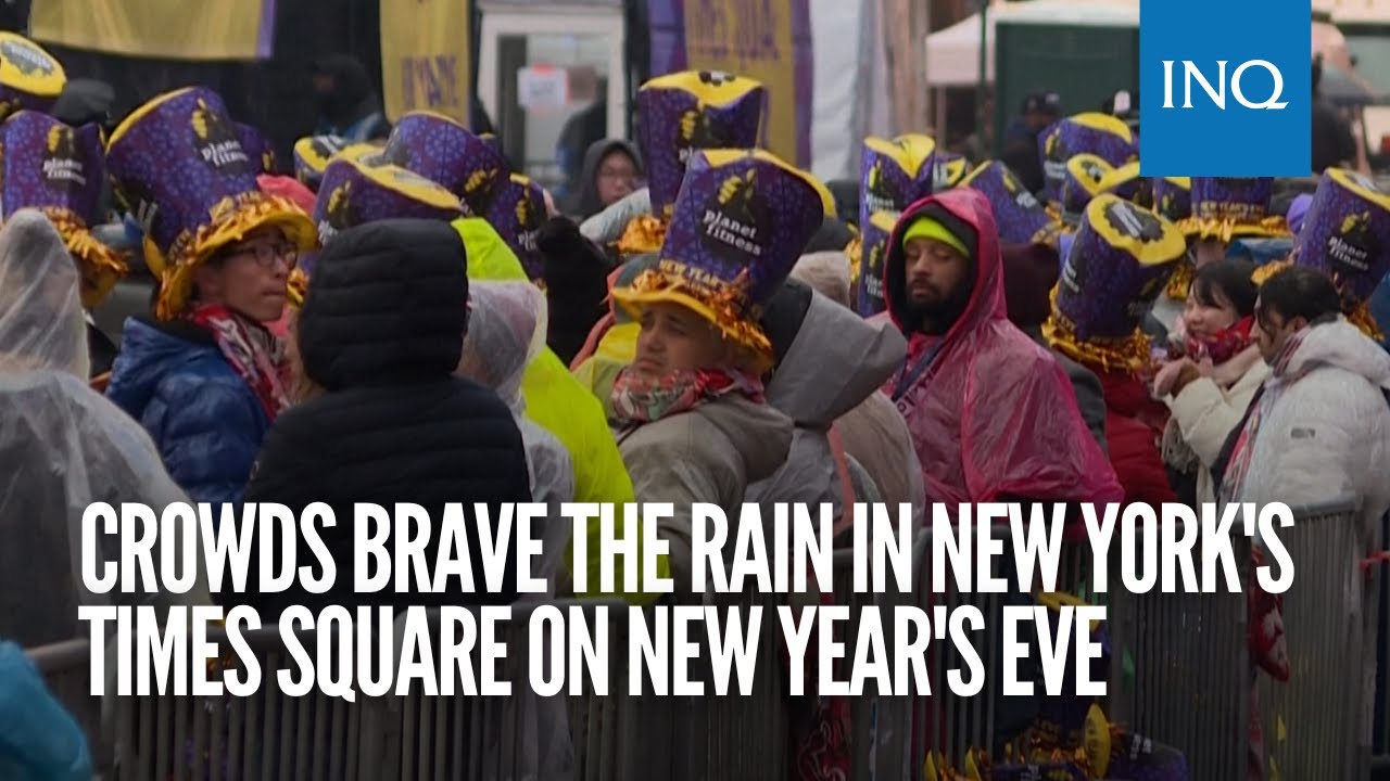 Crowds brave the rain in New York's Times Square on New Year's Eve