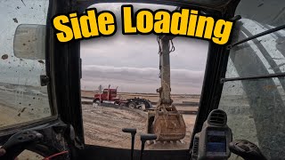 POV excavator SIDE LOADING onto lowboy trailer.