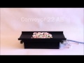 Conveyor transporting candy on nonstick tray