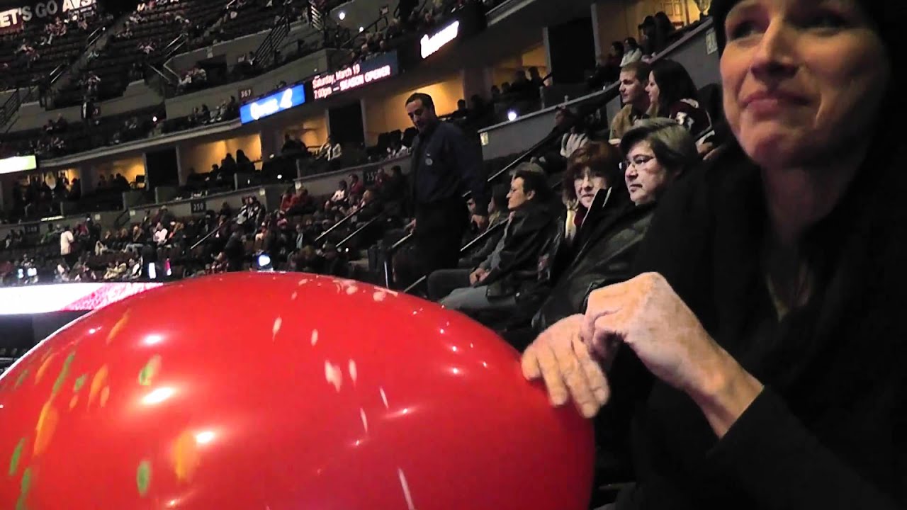 Balloon Mistress inflating a balloon at a Colorado Avalanche hockey game.MTS