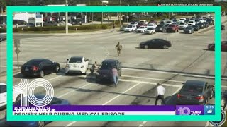 Watch as good Samaritans help stop car as driver suffers medical issue