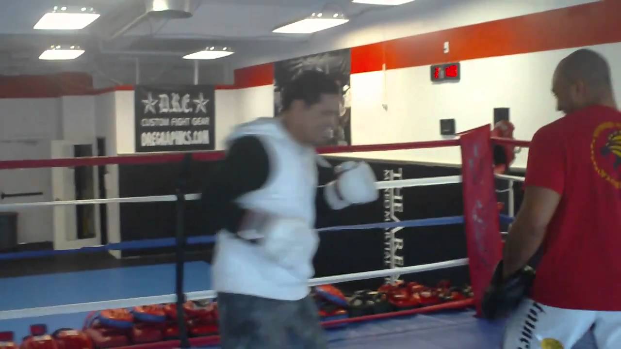 Saulo Ribeiro hitting boxing mitts with Kru Buck Grant at The Arena MMA
