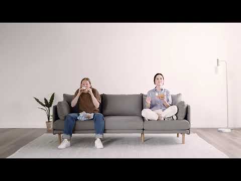 A Burrow modular sofa being assembled from separate pieces