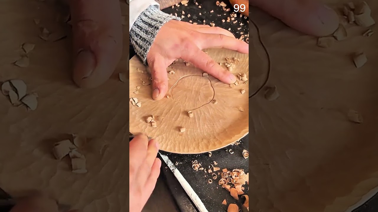 Carving tool shapes circular wood, textured bowl pattern emerges