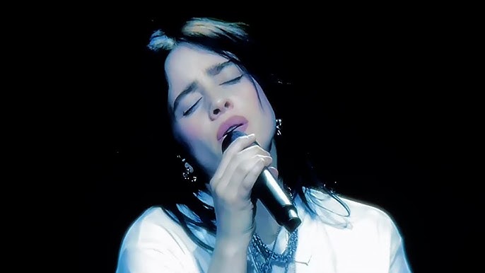 Billie Eilish immersed in a haunting live performance