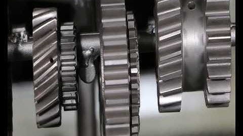 How do I use the hanger type shot blasting machine to clean the gears?