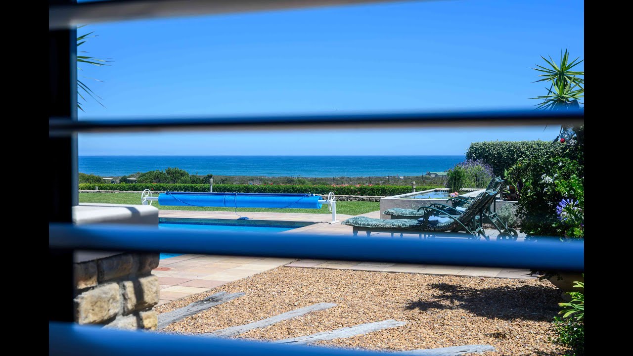 Architectural masterpiece with full sea views for sale on Atlantic Beach Golf Estate, Cape Town.