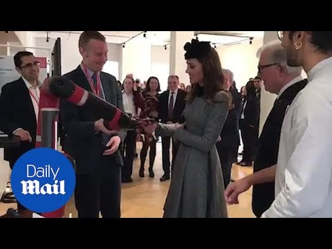 Kate shakes a robotic hand on her visit to Kings College London