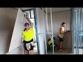 Pro drywall crew working fast for 15 minutes on new home construction