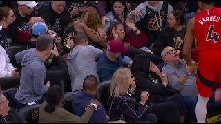 Donovan Mitchell deflects the pass and then jumps into the third row, as he cannot stop his momentum