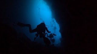 Scuba Divers Explore The Mysterious  Secret Cave  Of The Galapagos Islands