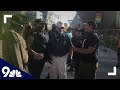 Who else was armed during the Denver shooting? Footage reveals someone shouted 'he's got magazines in his coat' after unlicensed security guard shot dead Patriot Muster protester as police say TWO guns were recovered from the scene