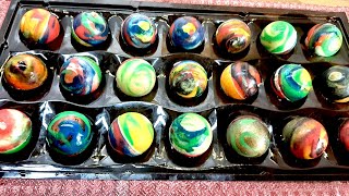 Homemade colored chocolate candies. Cacao butter tempering