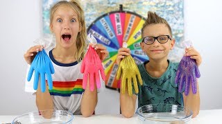 Karina and ronald use gloves to make slime, spin the mystery wheel
pick their slime ingredients from gloves!!! watch how they snip get
their...