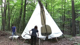 Setting up a teepee in the forest