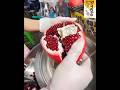 Making a fresh pomegranate juice - street food drink