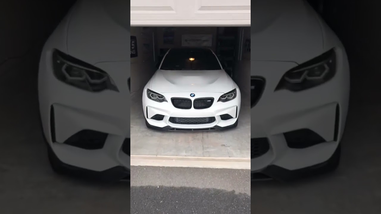 Sleek Reveal: White Sports Car Unveiled from Garage