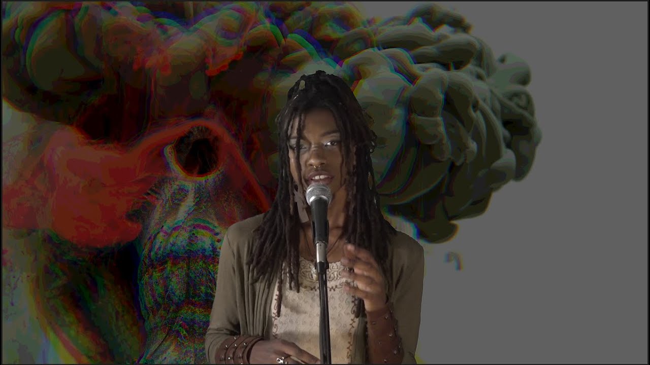 Sage Violet singing into a microphone on the OfSoundMind Music Podcast