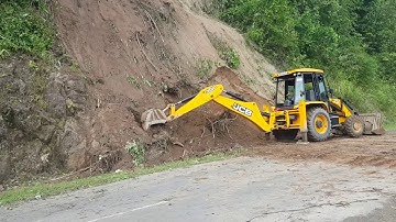 jcb backhoe loader clearing landslide