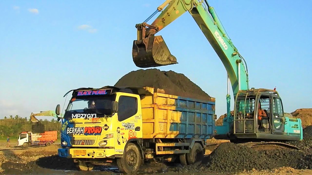 Excavator Digging Over Loading Sand Into Dump Truck 