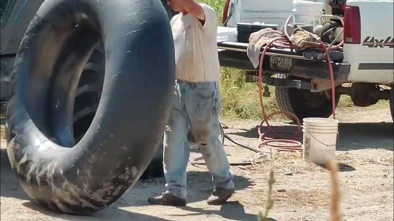 Changing a rear tractor tire tube filled with liquid ballast. July 16