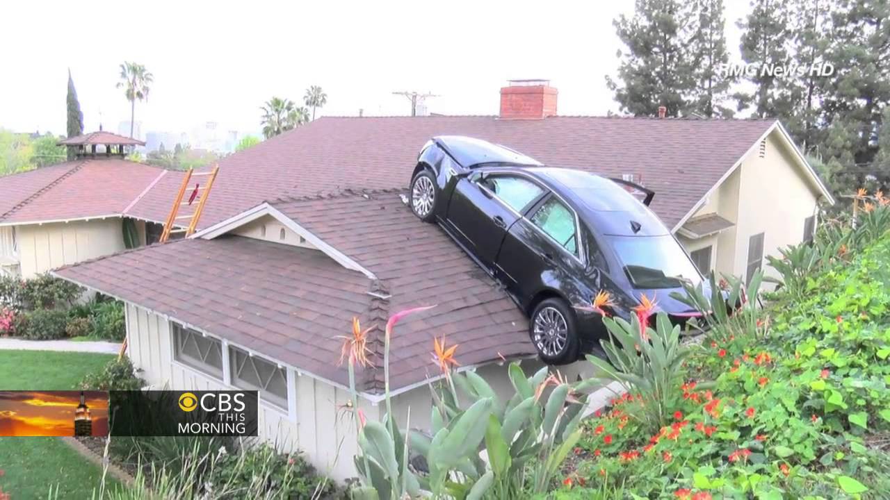 Airborne car ends up on garage roof - YouTube