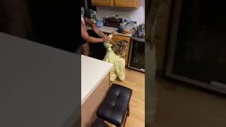 Girl jumps in guys hands to attempt dirty dancing dance move but falls in the kitchen