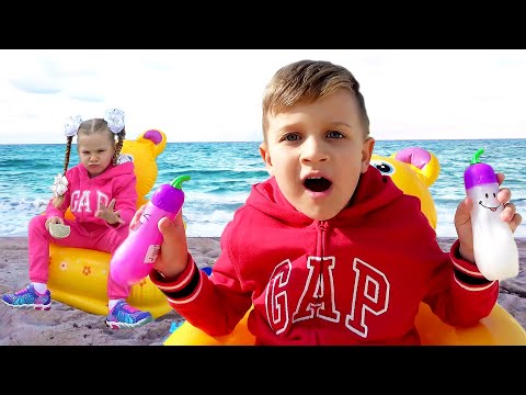 Roma and Diana play with dad on the beach