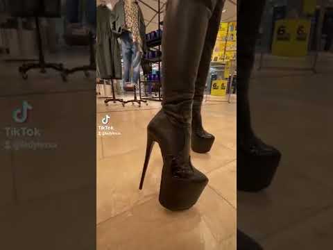 Leather boots and wetlook leggings. Walking in shopping mall in high heels.